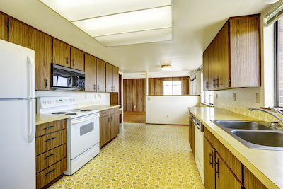 Outdated kitchen, 1970 style with gold linoleum floor