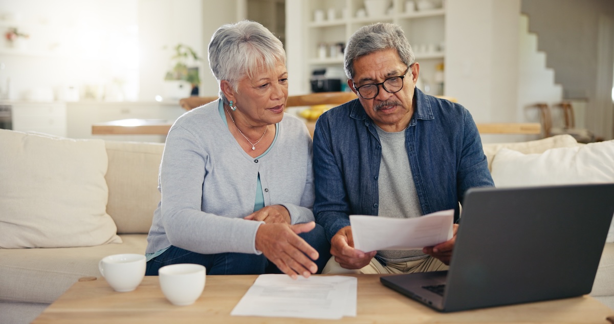 Senior homeowners reviewing finances, reverse mortgage leads for mortgage lenders